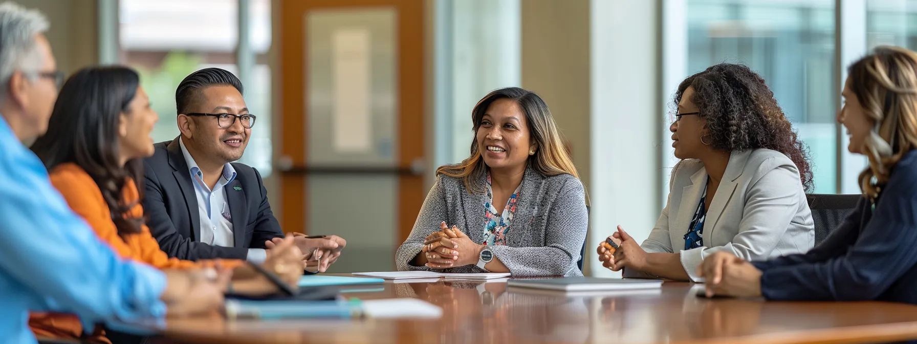 a group of diverse employees gathered around a conference table, engaged in a discussion with a confident and inspirational leader.